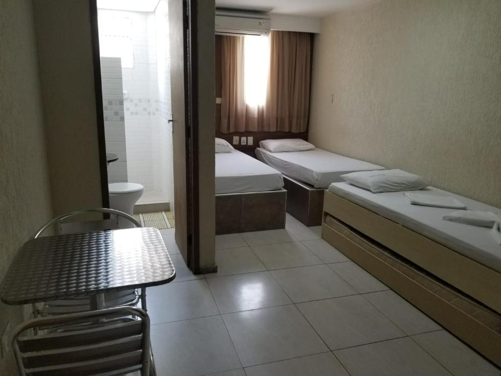 Cama ou camas em um quarto em Hotel Uzi Praia