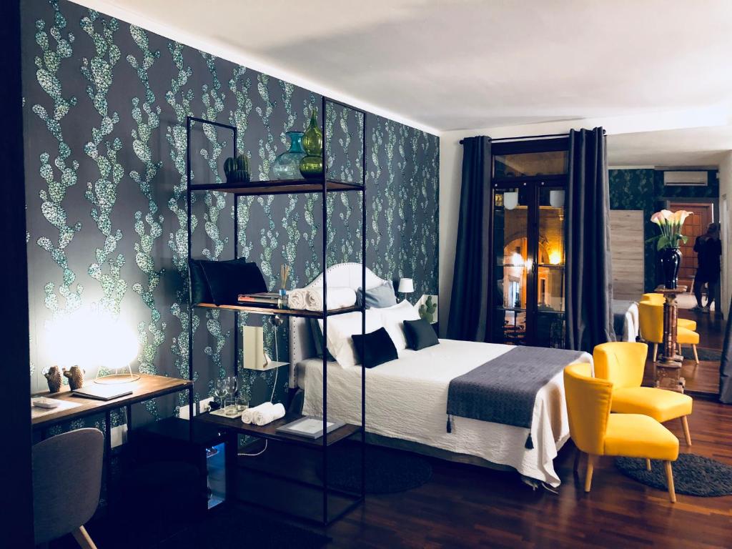 a bedroom with a bed and a desk and a chair at Palazzina300 in Treviso