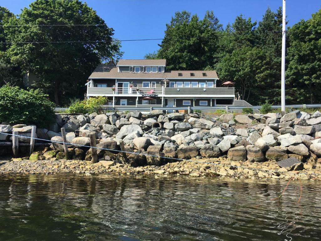 a house with a bunch of rocks next to the water at SeaWatch Bed & Breakfast in Halifax