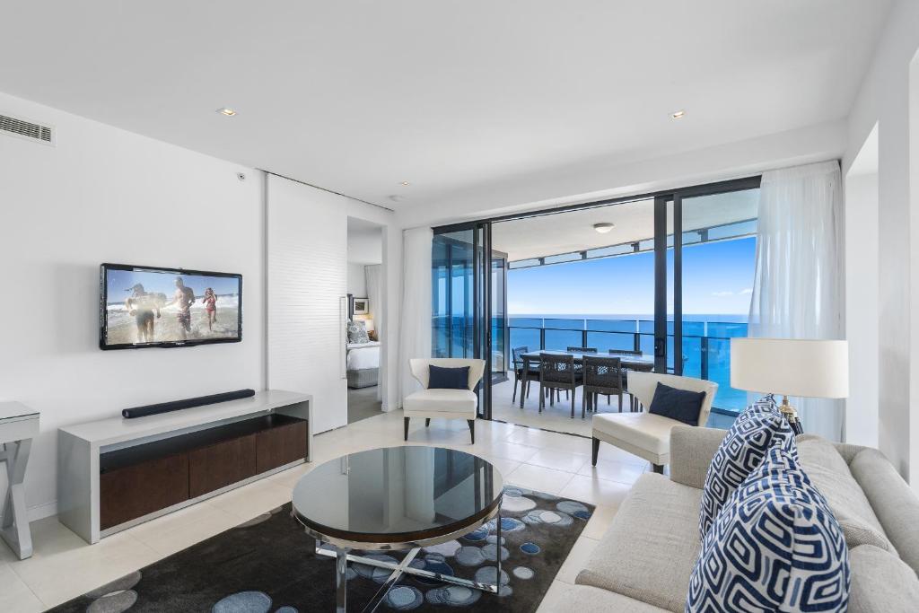 a living room with a view of the ocean at Soul Beachfront Apartments - HR Surfers Paradise in Gold Coast