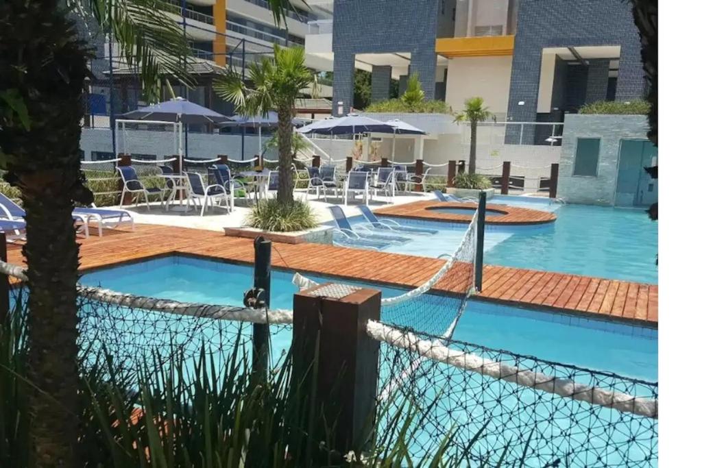 a view of the pool at the resort at Apto pé-na-areia em Bertioga - Indaia Home Club in Bertioga