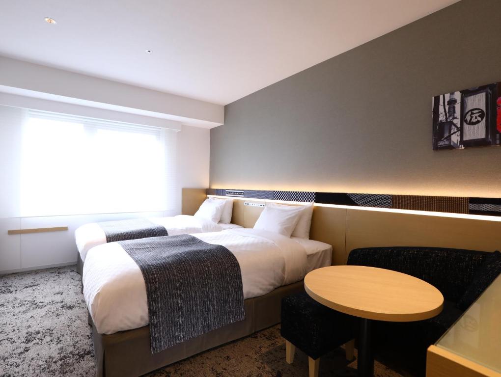 Postel nebo postele na pokoji v ubytování Hotel Gracery Asakusa