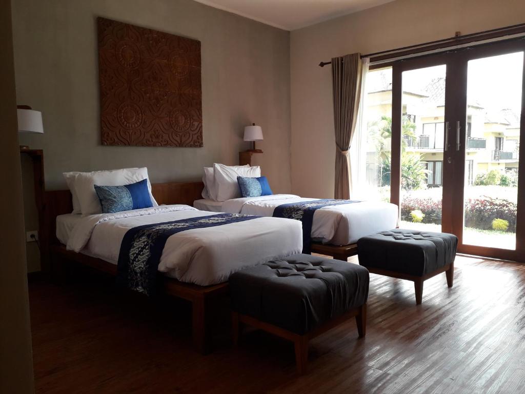 Postel nebo postele na pokoji v ubytování Manyi Village Ubud