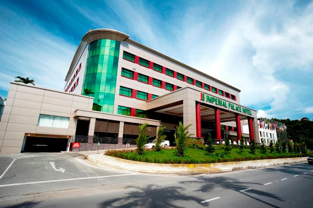 a large building with a street in front of it at Imperial Palace Hotel in Miri