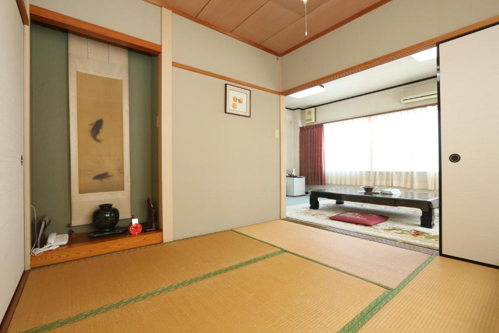 Postel nebo postele na pokoji v ubytování Ryokan Kibun