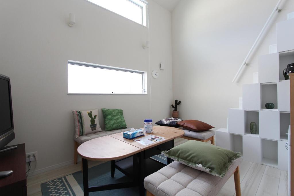 a living room with a table and a couch at Shibuya Stay Tokyo A202 in Tokyo