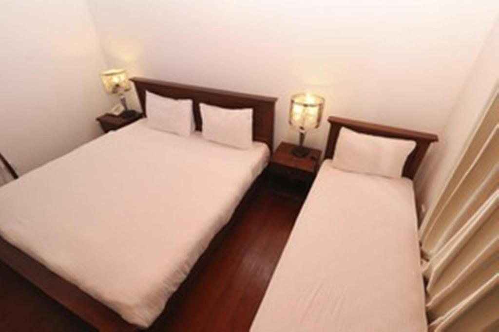 Postel nebo postele na pokoji v ubytování Daffodil's Hotel