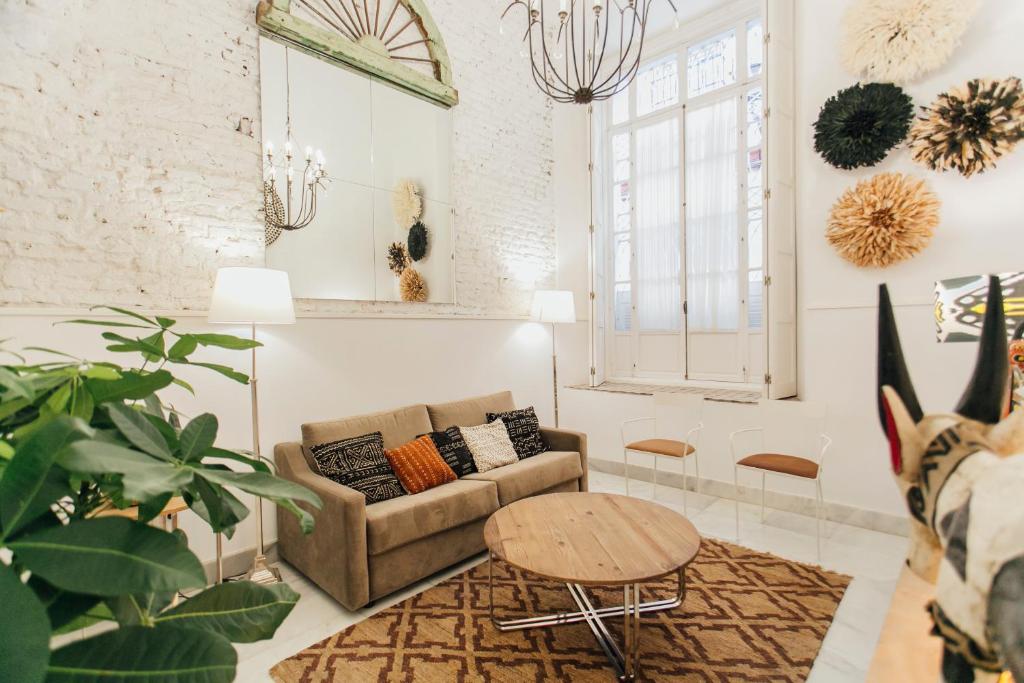 a living room with a couch and a table at CSE Pajaritos in Seville