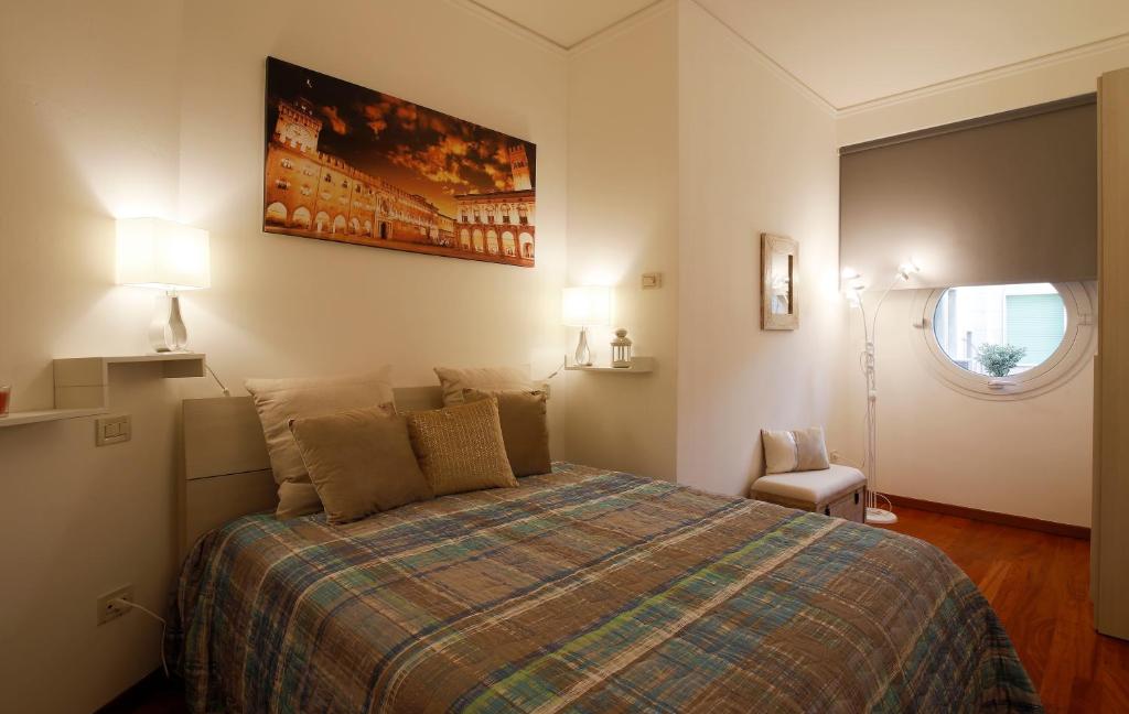 ein Schlafzimmer mit einem großen Bett und einem Fenster in der Unterkunft Bologna Central Apartment in Bologna