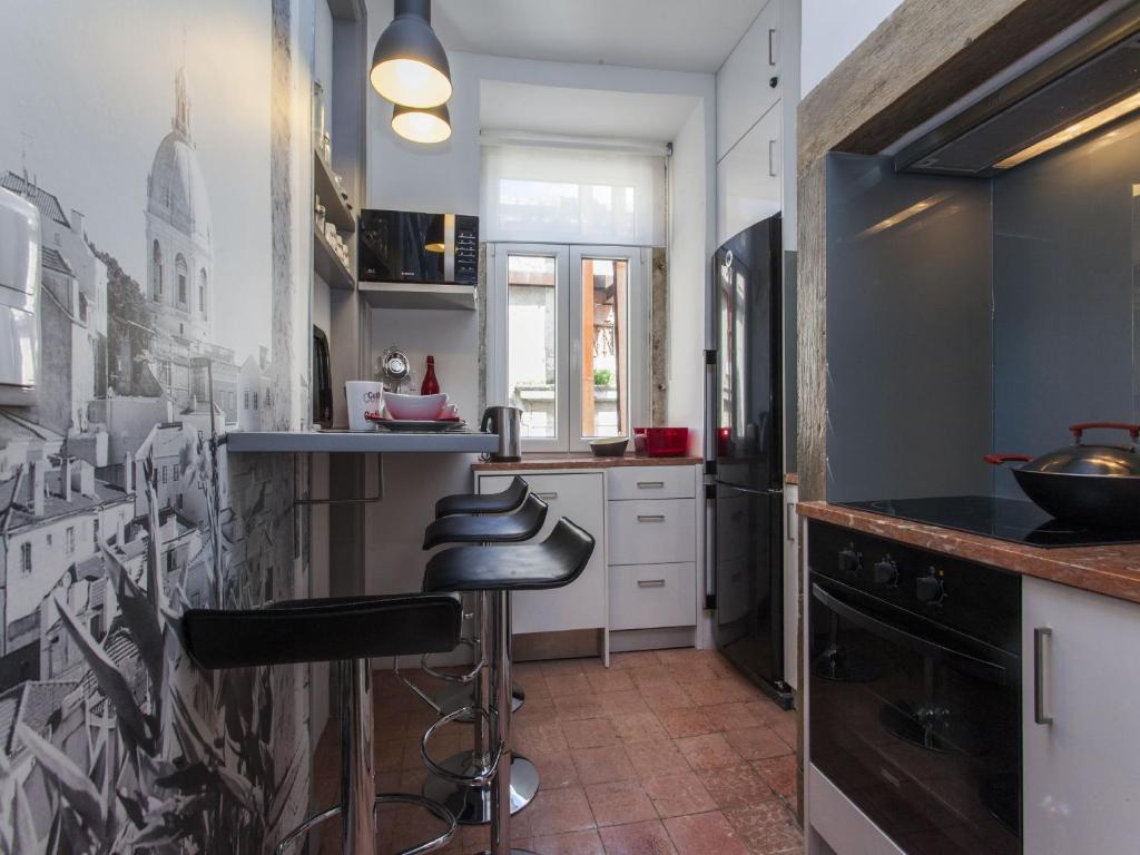 una cocina con barra y un bar con taburete en Historical Lisbon Apartments, en Lisboa