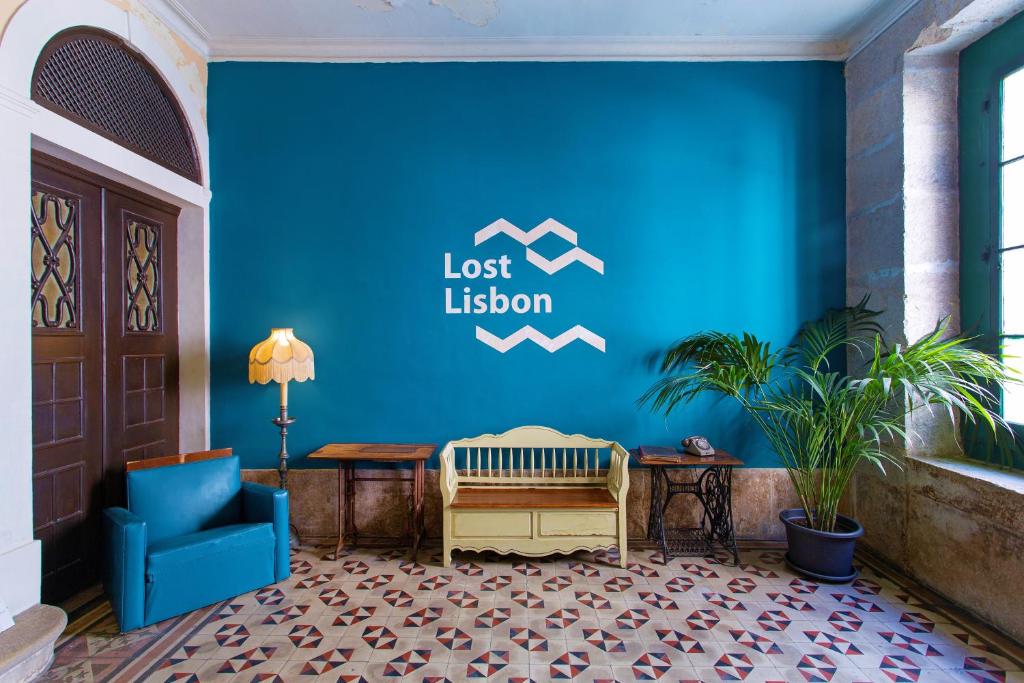 a lobby with a blue wall with a lost illusion sign at Lost Lisbon :: Chiado House in Lisbon