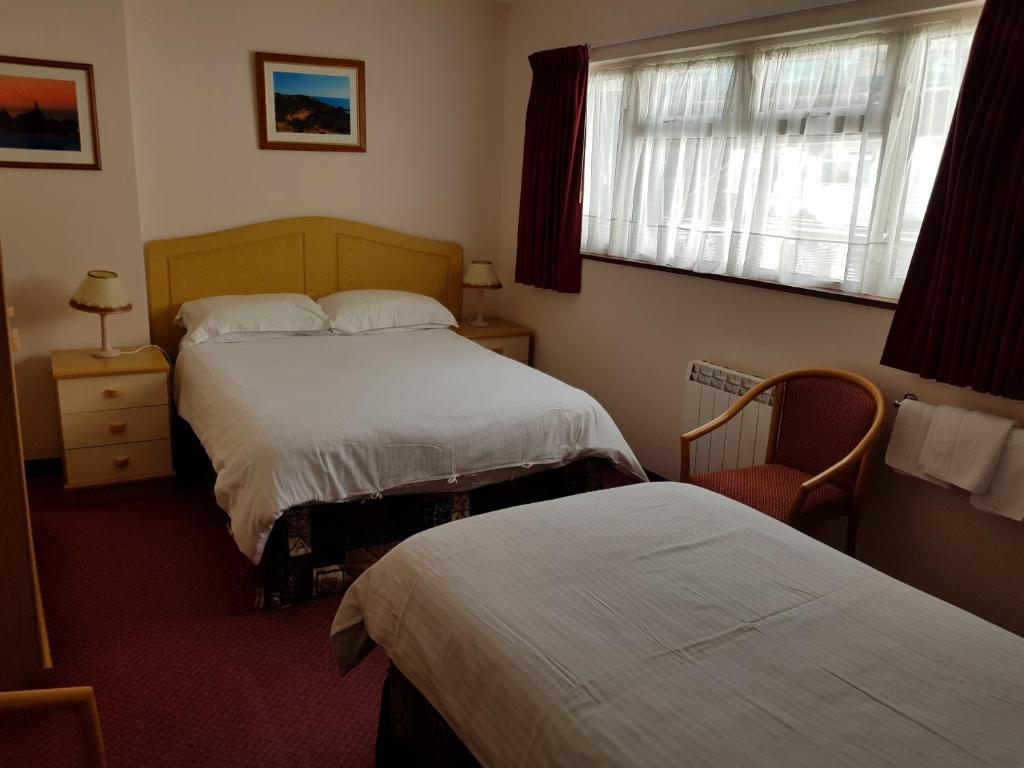 Postel nebo postele na pokoji v ubytování Bon Viveur Guest House