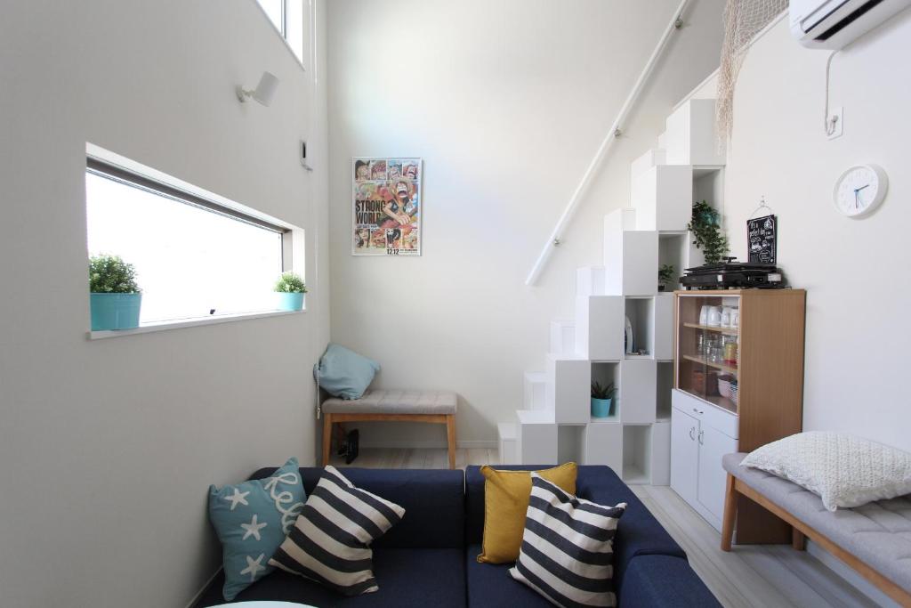 a living room with a blue couch and a window at Shibuya Anon #B204 in Tokyo