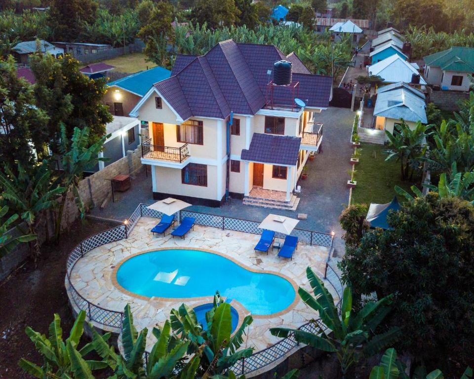 an aerial view of a house with a swimming pool at Rayan Apartments & Safaris in Arusha