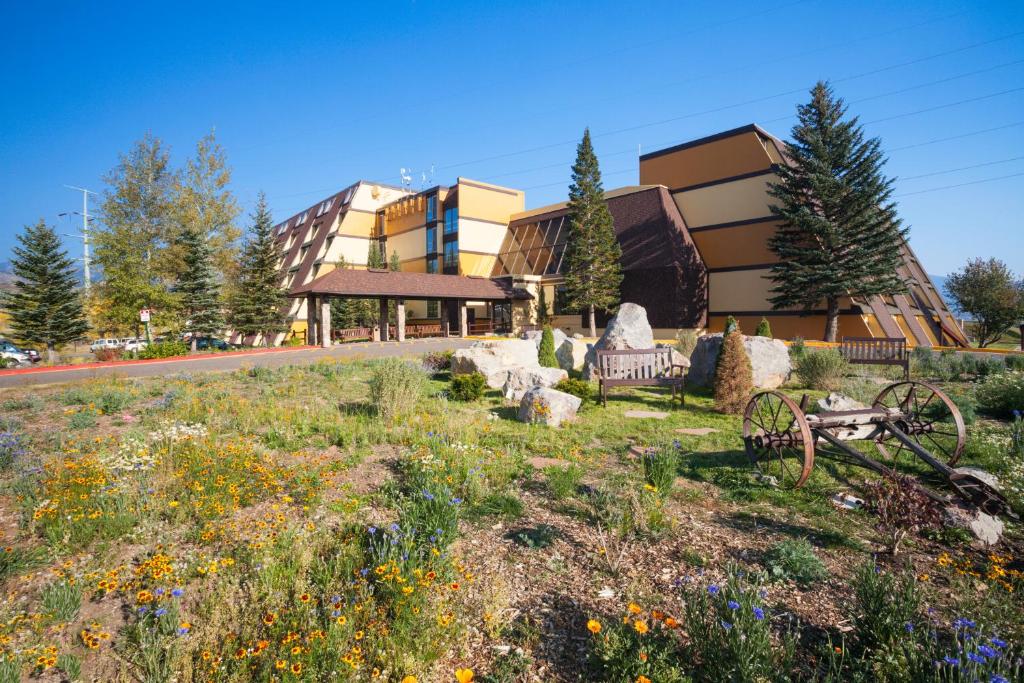 a building with a field of flowers in front of a building at Legacy Vacation Resorts Steamboat Springs Hilltop in Steamboat Springs