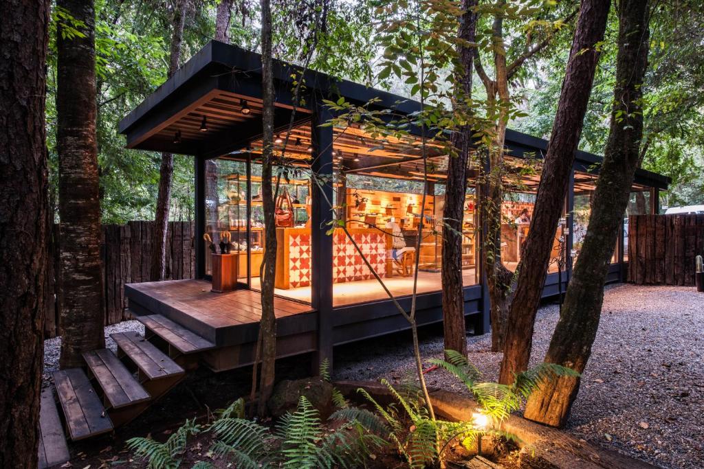a tree house in the woods with a swing at Rodavento Boutique Hotel & Spa in Valle de Bravo