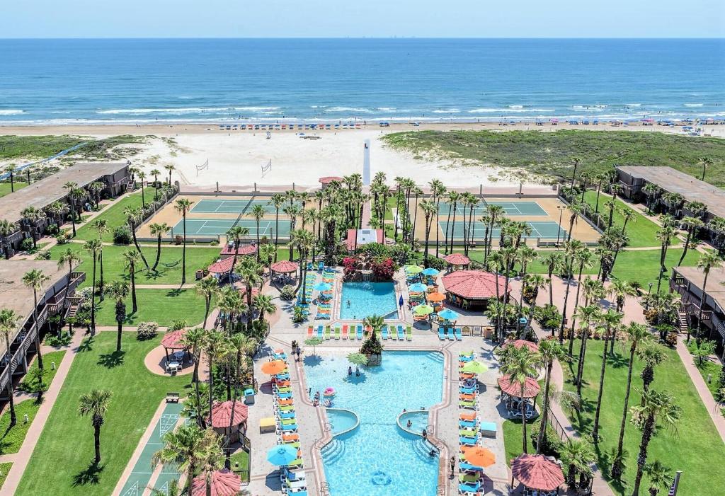 an aerial view of a resort with a pool and the beach at Isla Grand Beach Resort in South Padre Island
