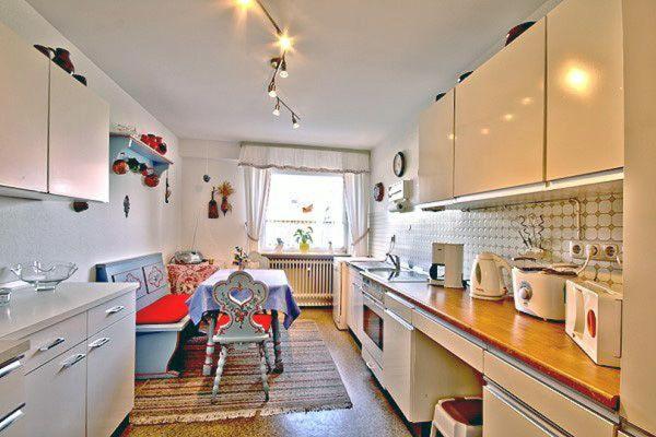 a kitchen with a table and a couch in a room at Ferienwohnung-STREUTALBLICK in Fladungen