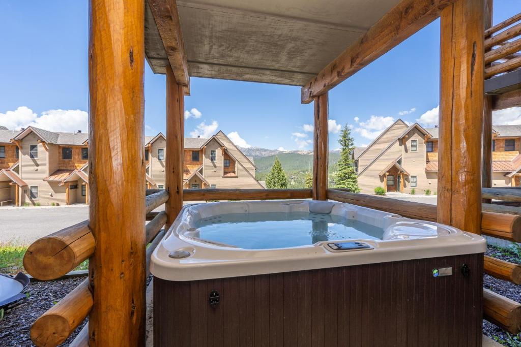 a jacuzzi tub on the porch of a house at Saddle Ridge I2 in Big Sky