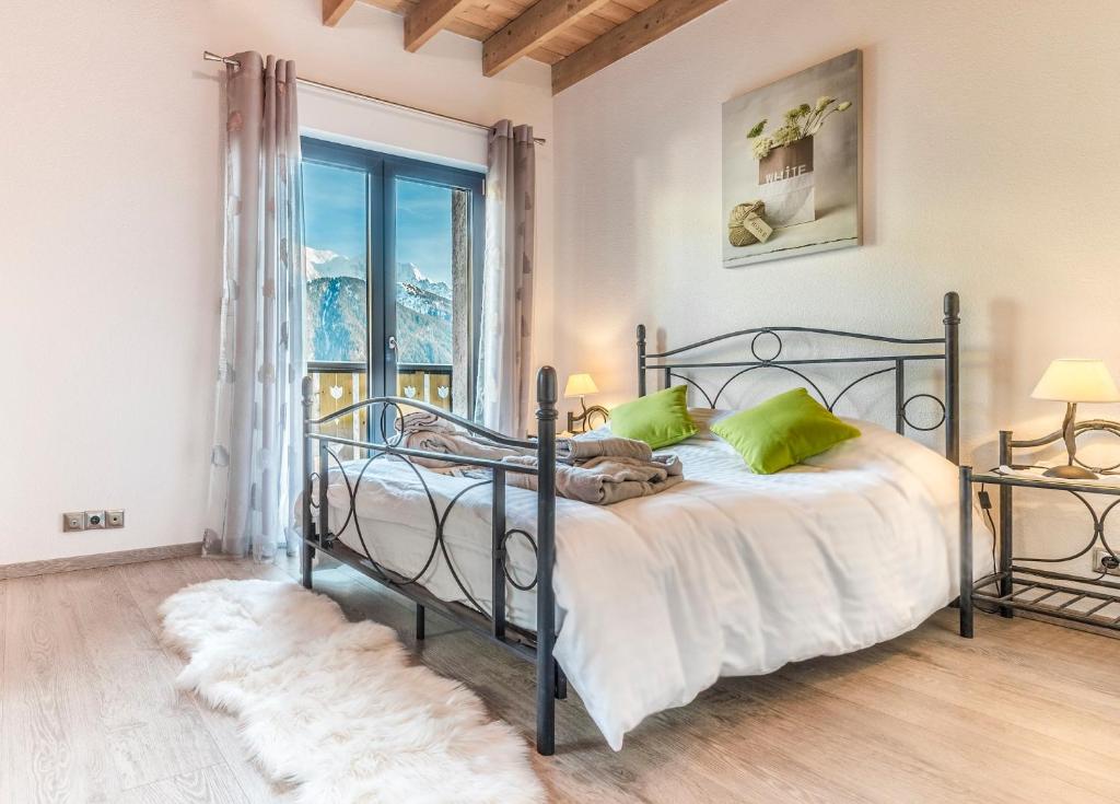 a bedroom with a bed and a large window at Les Edelweiss Mont-Blanc - Gîte Classé 3 Etoiles in Passy