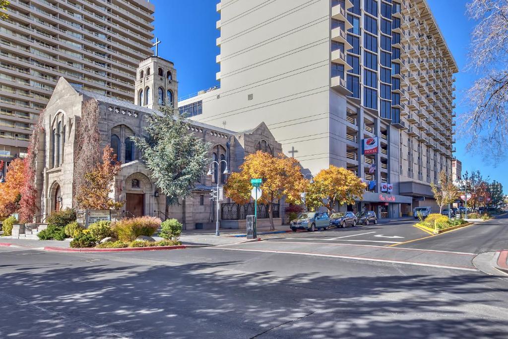 a church with a tower on a street with buildings at Plaza Resort Club Reno in Reno