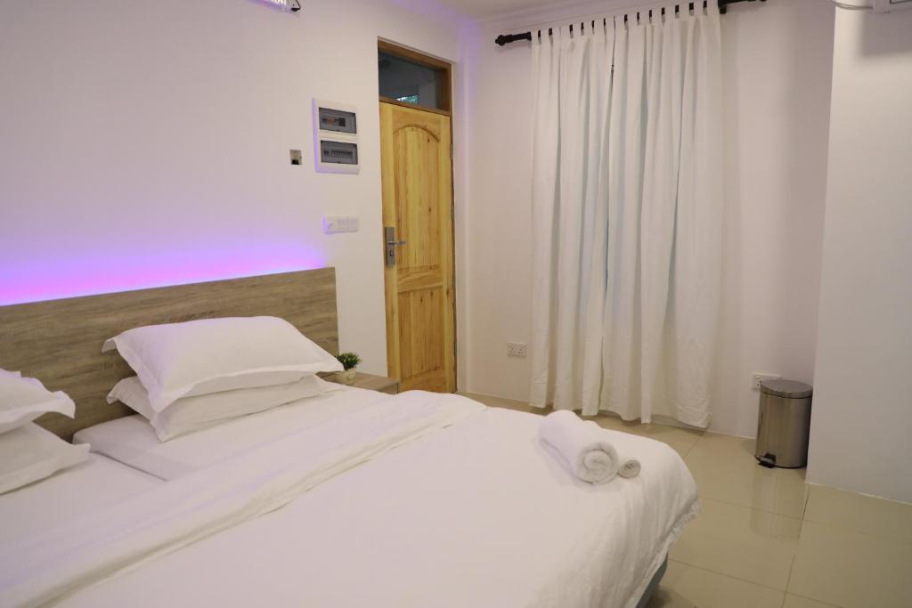 Postel nebo postele na pokoji v ubytování Moodhu Surf House