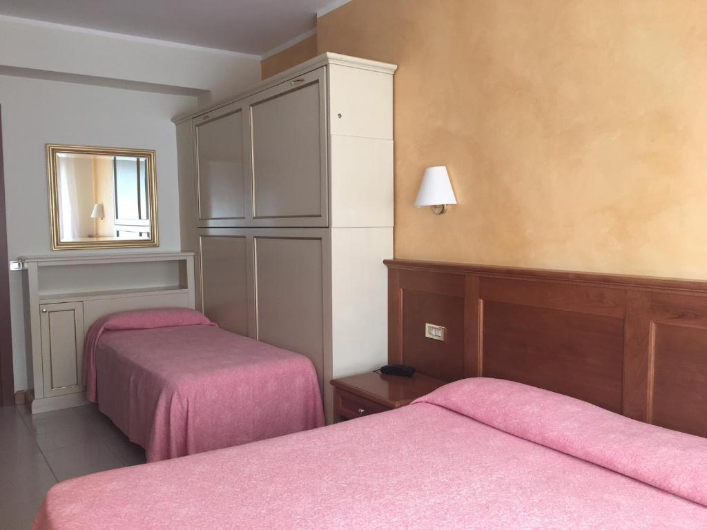 Postel nebo postele na pokoji v ubytování Hotel Sporting