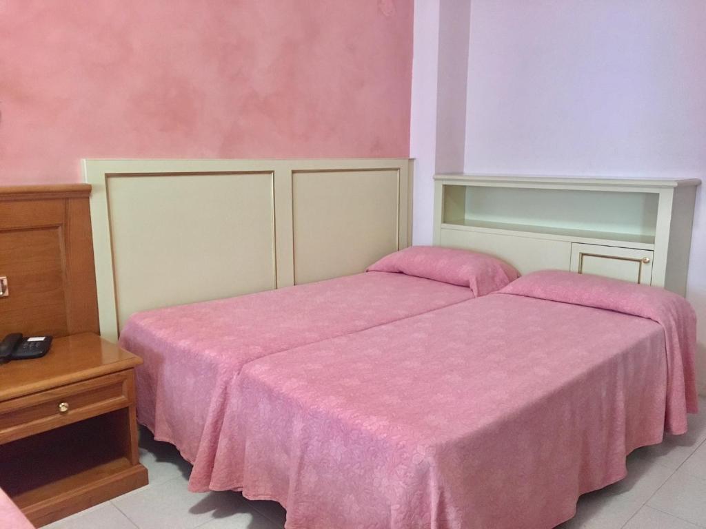 Postel nebo postele na pokoji v ubytování Hotel Sporting