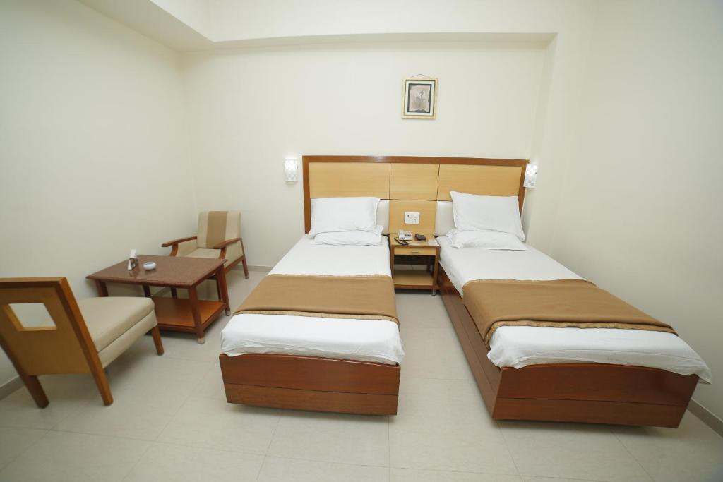 En eller flere senger på et rom på Jaya Residency