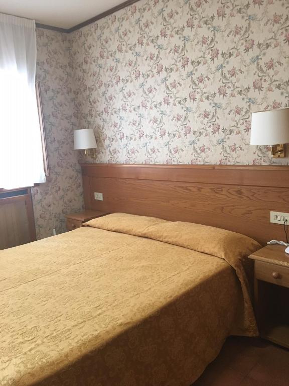 Postel nebo postele na pokoji v ubytování Hotel Sporting