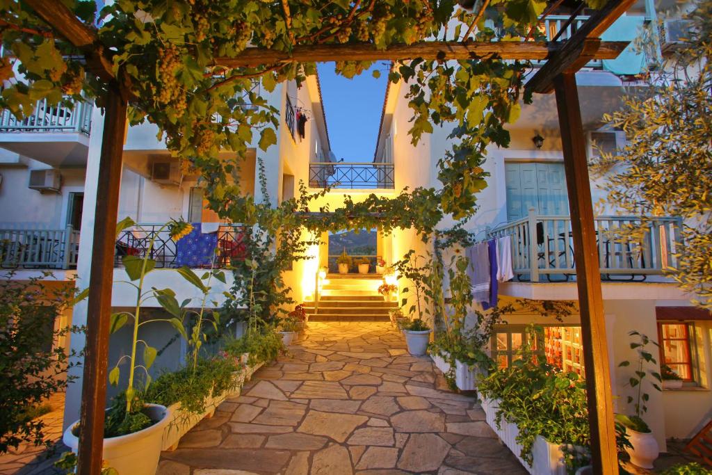 a hallway of a building with a bunch of plants at Pansion Prodromina in Skopelos Town