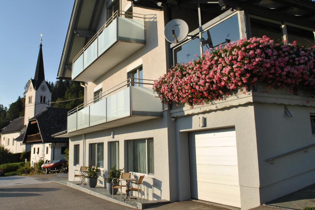 a building with flowers on the side of it at Ferienwohnung St. Martin 28 in Techelsberg am Worthersee