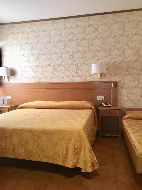 Postel nebo postele na pokoji v ubytování Hotel Sporting