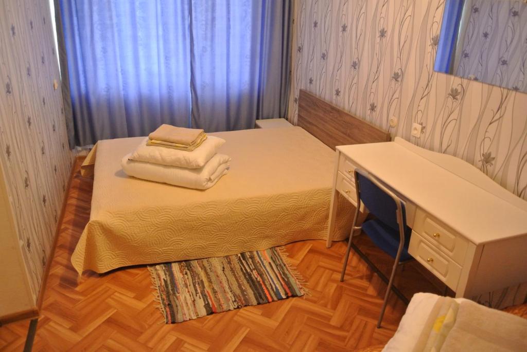a bedroom with a bed with two towels on it at Narva Econom in Narva