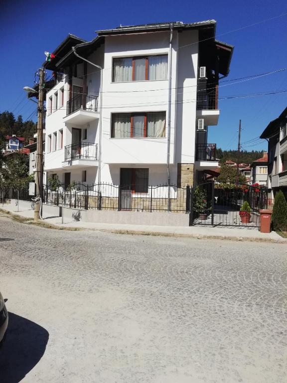 a white building on the side of a street at Iceberg in Tryavna