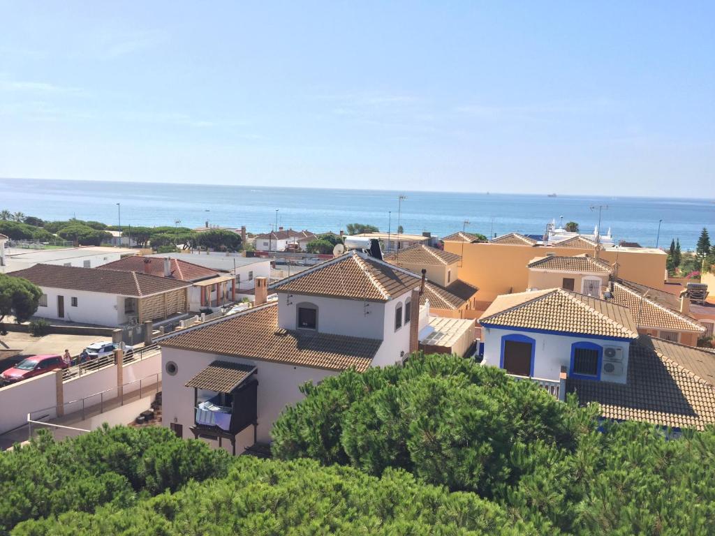 a group of houses with the ocean in the background at Apartamento Las Gacelas in Mazagón