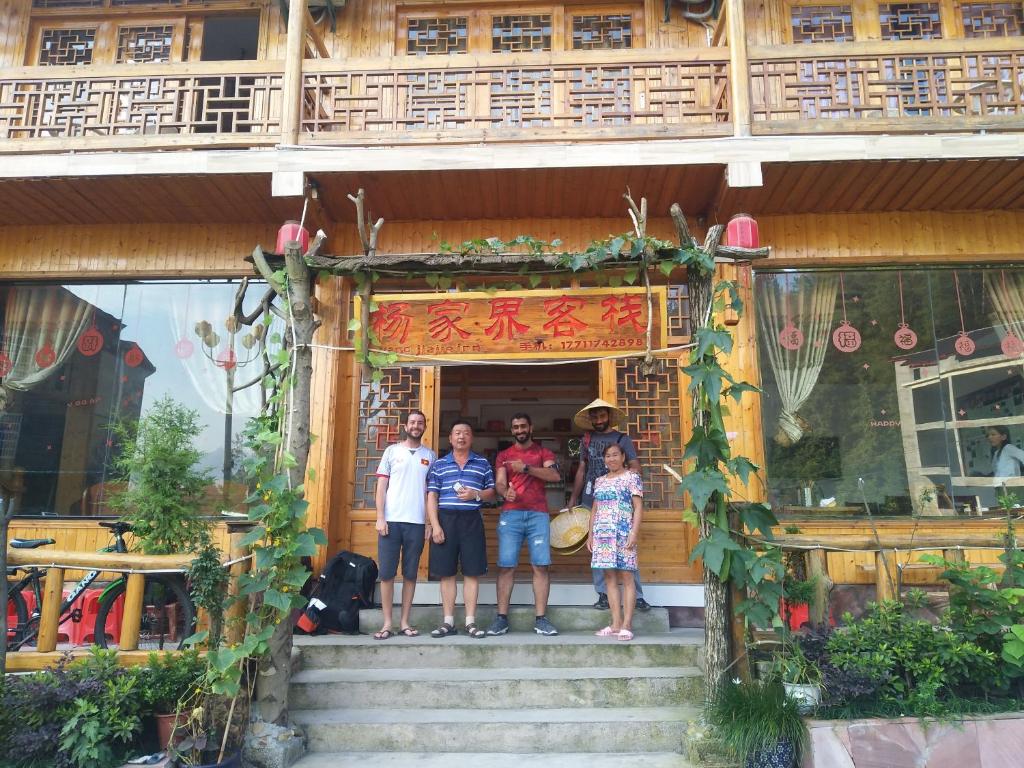 a group of people standing outside of a building at Yangjiajie Inn in Zhangjiajie