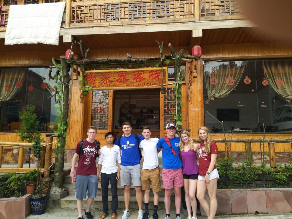 a group of people standing in front of a building at Yangjiajie Inn in Zhangjiajie