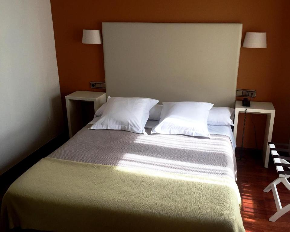 A bed or beds in a room at Hotel Ovetense