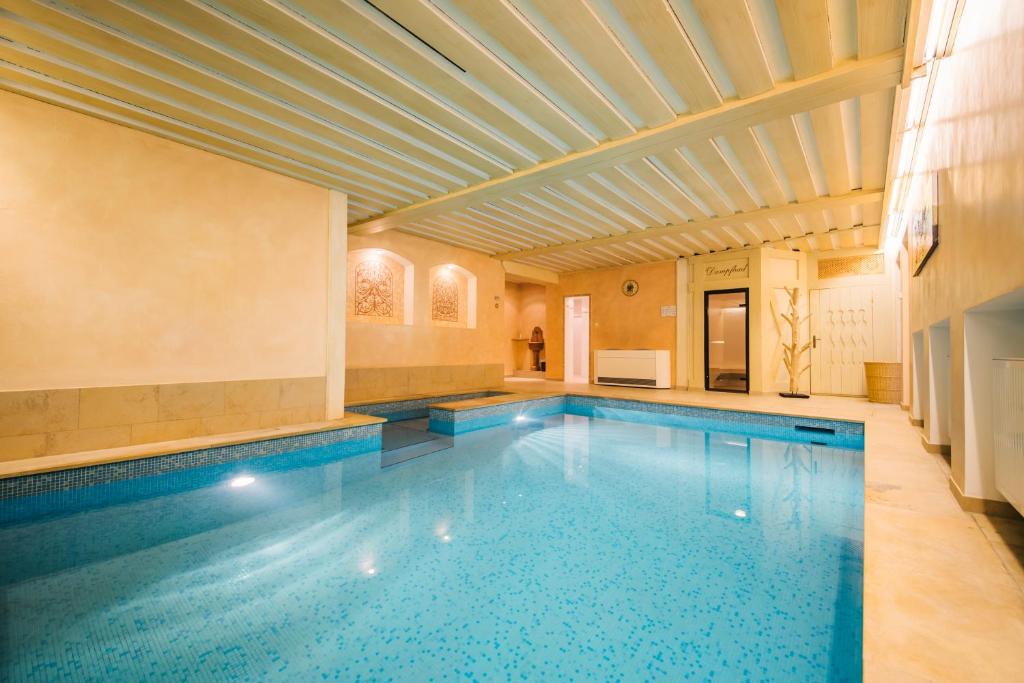 a swimming pool in a house with a ceiling at Hotel Dr Otto Murr B&B in Sankt Anton am Arlberg