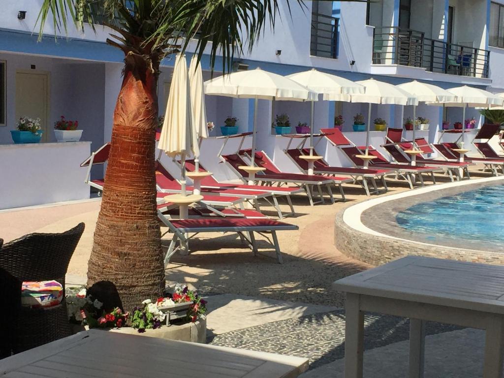 a resort with lounge chairs and a swimming pool at Hotel ANTAG in Shëngjin