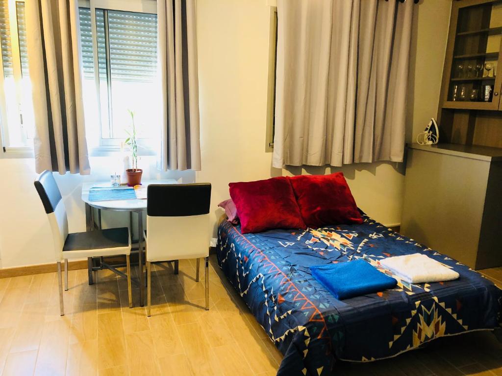 a bedroom with a bed and a table with chairs at Week-end Porte de Clichy in Clichy