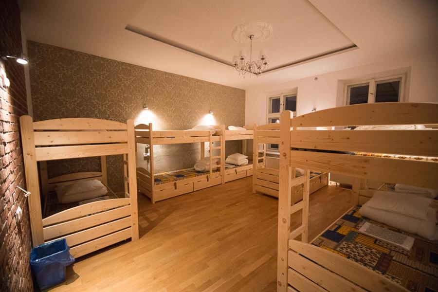 a large room with three bunk beds in it at Greg&Tom Beer House Hostel in Krakow