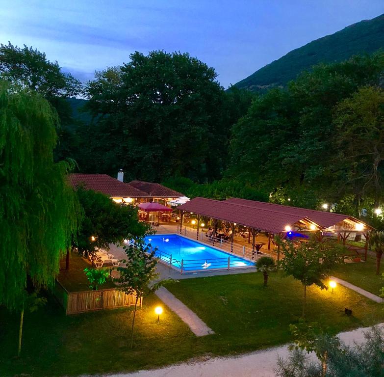 an overhead view of a swimming pool at night at Dipla Sto Potami (Next To The River) in Stathmos Terovou
