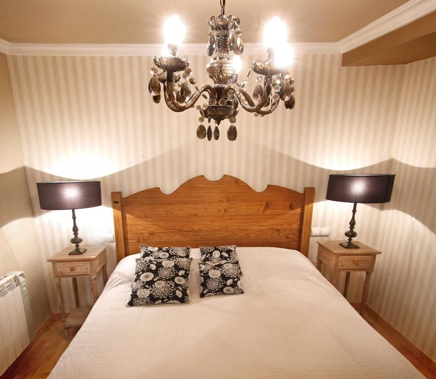 Postel nebo postele na pokoji v ubytování Apartamentos Alcoba de Baco
