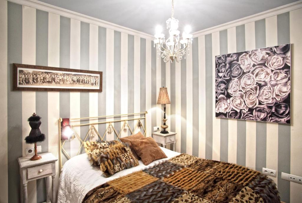 Postel nebo postele na pokoji v ubytování Apartamentos Alcoba de Baco
