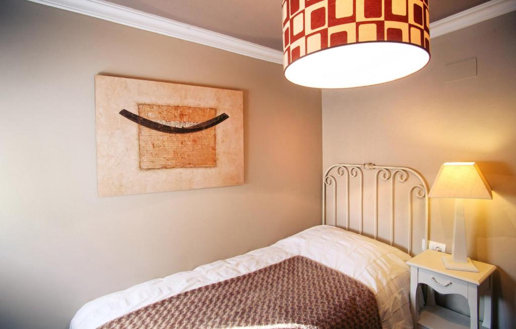 Postel nebo postele na pokoji v ubytování Apartamentos Alcoba de Baco