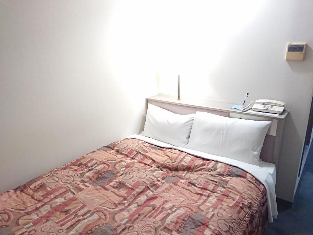 Postel nebo postele na pokoji v ubytování Hotel Crown Hills Imabari
