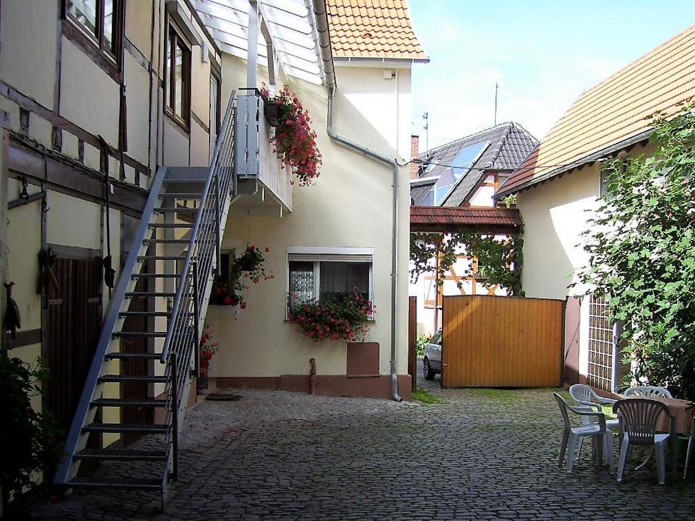 a staircase leading to a house with a table and chairs at Weingut & Gästehaus Nagel in Kapellen-Drusweiler