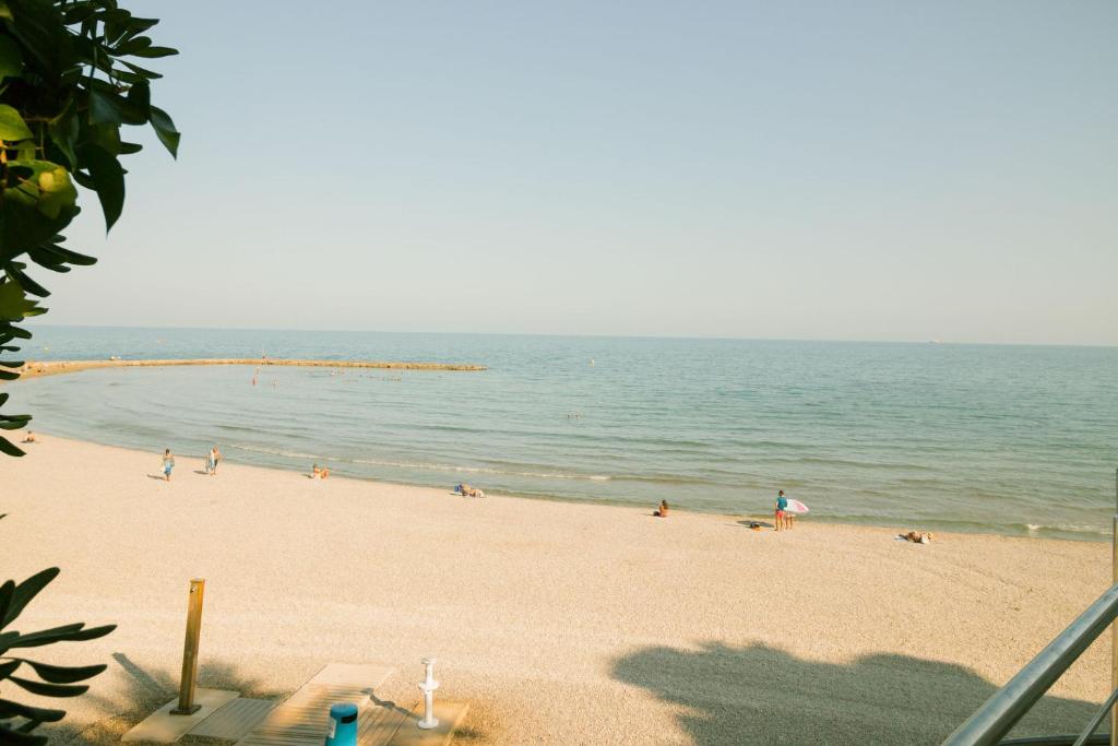 a group of people on a beach near the water at Oporto in Benicàssim